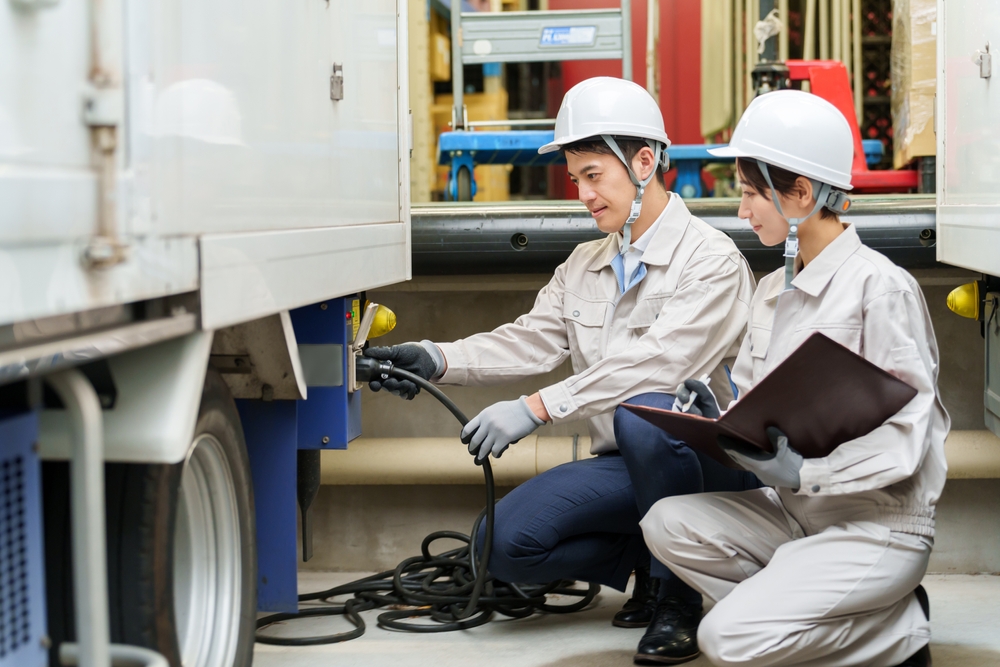 Technician performing maintenance on a commercial electric vehicle
